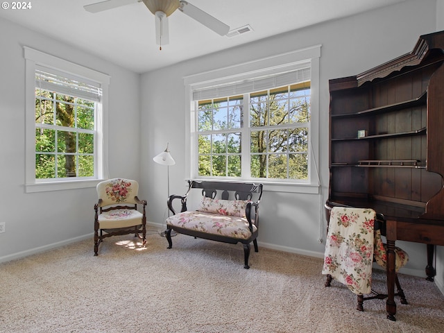 sitting room featuring carpet, visible vents, ceiling fan, and baseboards