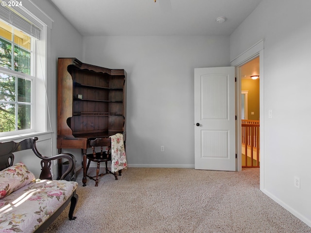 sitting room featuring carpet flooring and baseboards