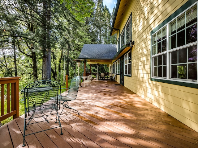 wooden terrace with outdoor dining area