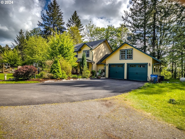 view of front facade with a front yard and driveway