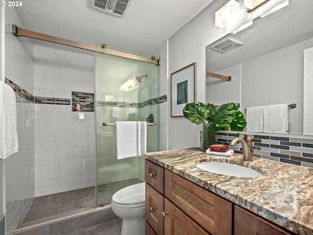 full bath with visible vents, a shower stall, toilet, and vanity