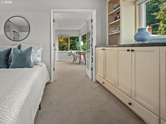 bedroom with light carpet and baseboards