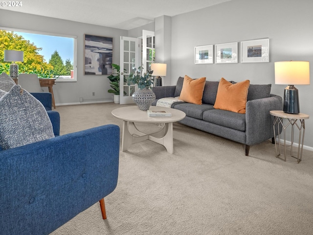 living room featuring carpet and baseboards