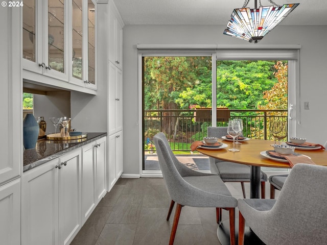 dining area featuring a textured ceiling and baseboards