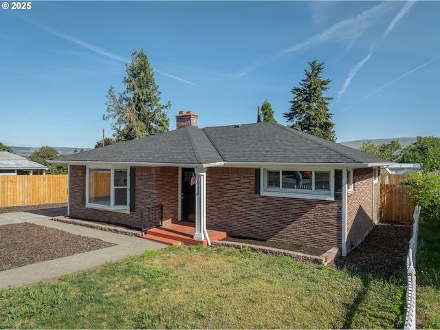 1911 E 12th St, The Dalles, OR 97058 - single story home with brick siding, a chimney, and roof with shingles