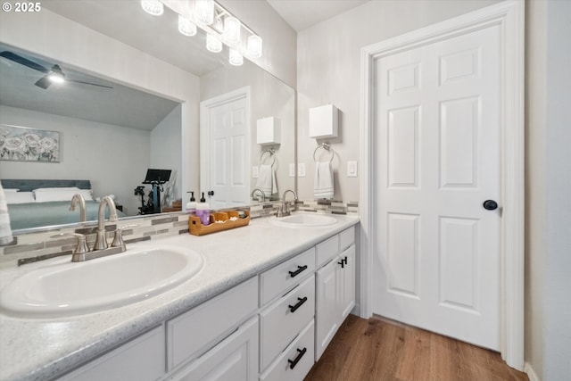 1686 NE 27th Ter, Gresham, OR 97030 - bathroom featuring double vanity, wood finished floors, and backsplash
