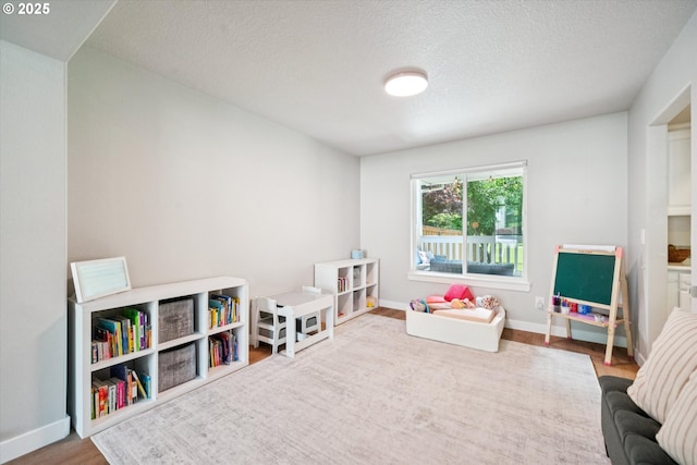 1686 NE 27th Ter, Gresham, OR 97030 - recreation room featuring wood finished floors and a textured ceiling