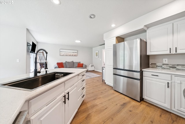 1686 NE 27th Ter, Gresham, OR 97030 - kitchen with freestanding refrigerator, light wood finished floors, recessed lighting, white cabinets, and light countertops