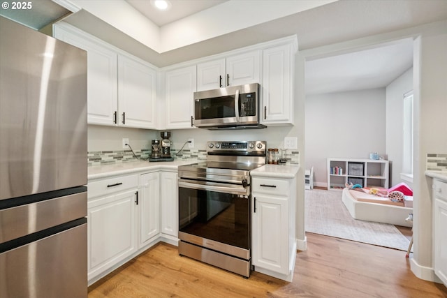 1686 NE 27th Ter, Gresham, OR 97030 - kitchen featuring stainless steel appliances, light wood finished floors, light countertops, white cabinetry, and recessed lighting