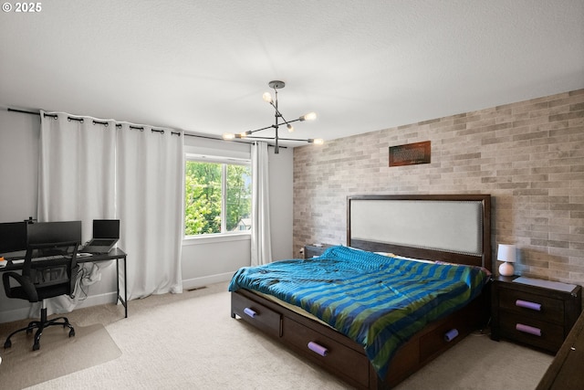 bedroom featuring brick wall, a chandelier, and light carpet