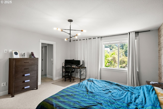 bedroom with baseboards, light colored carpet, and a notable chandelier