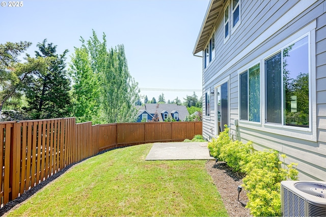 view of yard with a patio, a fenced backyard, and central AC