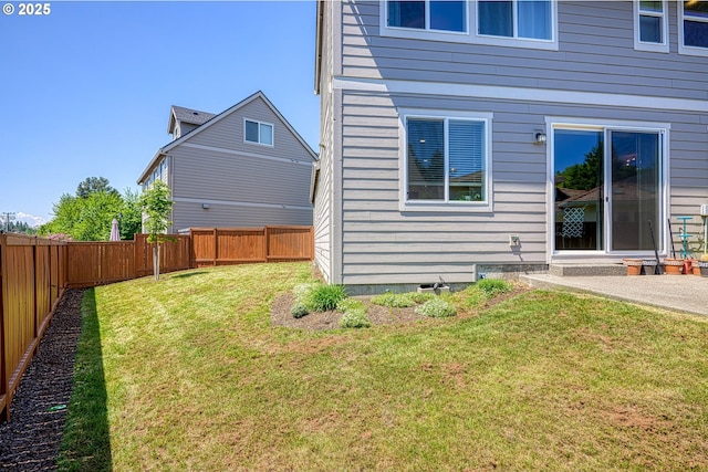 back of property with a lawn and a fenced backyard