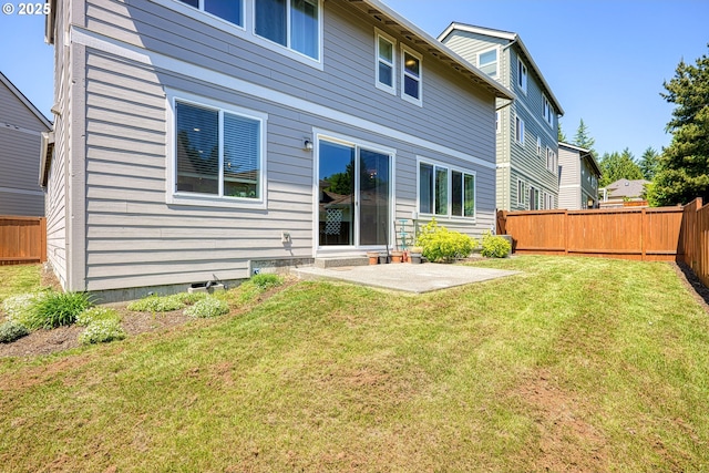 back of house featuring a patio, a fenced backyard, and a lawn