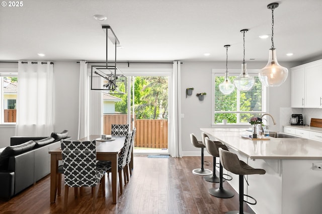 dining area with recessed lighting, a notable chandelier, and dark wood-type flooring