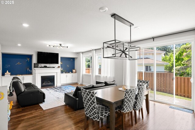dining area featuring recessed lighting, wood finished floors, and a fireplace