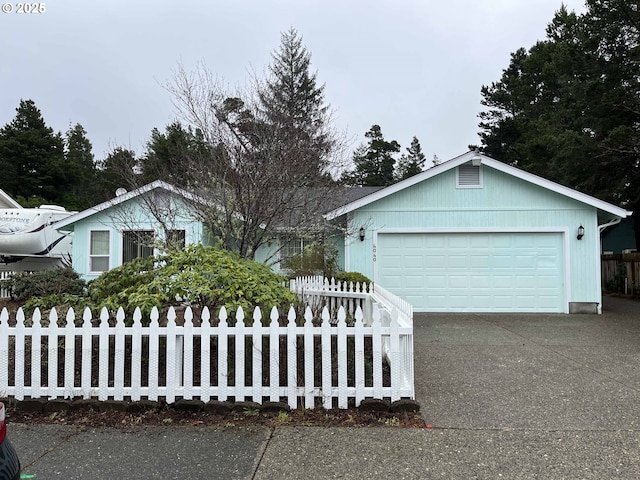 ranch-style house with a fenced front yard, driveway, and a garage