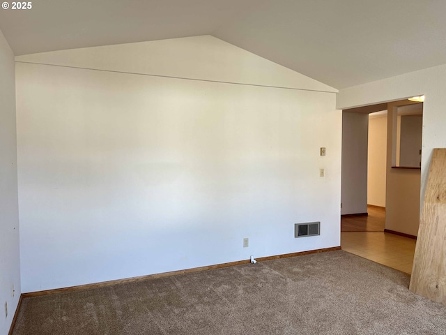 4040 Munsel Creek Dr, Florence, OR 97439 - empty room with baseboards, visible vents, vaulted ceiling, and carpet flooring