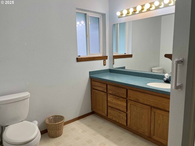 4040 Munsel Creek Dr, Florence, OR 97439 - bathroom featuring toilet, tile patterned floors, baseboards, and vanity