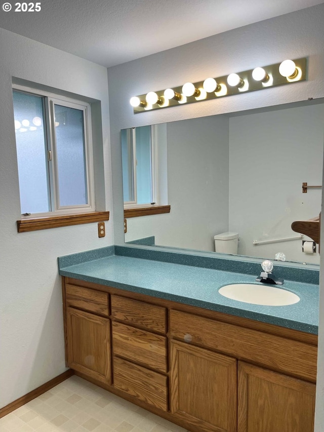 4040 Munsel Creek Dr, Florence, OR 97439 - bathroom featuring toilet, baseboards, and vanity