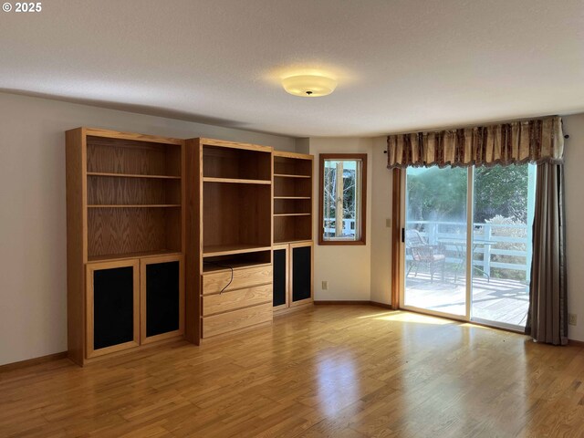4040 Munsel Creek Dr, Florence, OR 97439 - unfurnished living room with light wood-type flooring and baseboards