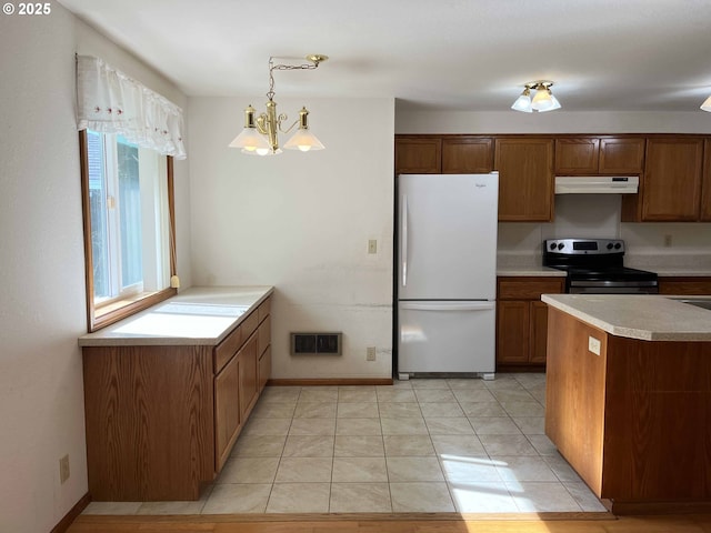 4040 Munsel Creek Dr, Florence, OR 97439 - kitchen featuring electric stove, brown cabinets, light countertops, freestanding refrigerator, and under cabinet range hood