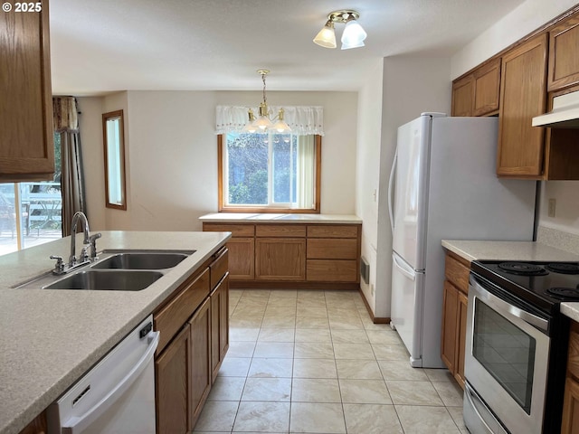 4040 Munsel Creek Dr, Florence, OR 97439 - kitchen with a sink, stainless steel electric range oven, brown cabinetry, and dishwasher