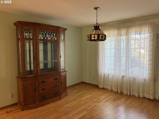 4040 Munsel Creek Dr, Florence, OR 97439 - kitchen with brown cabinetry, freestanding refrigerator, electric stove, and under cabinet range hood