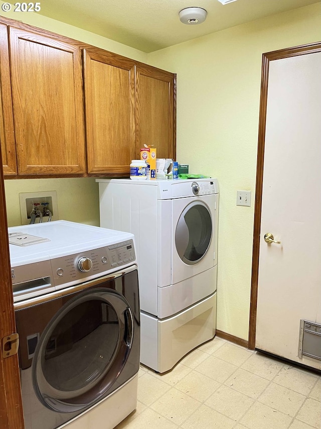 4040 Munsel Creek Dr, Florence, OR 97439 - clothes washing area featuring baseboards, cabinet space, light floors, and separate washer and dryer