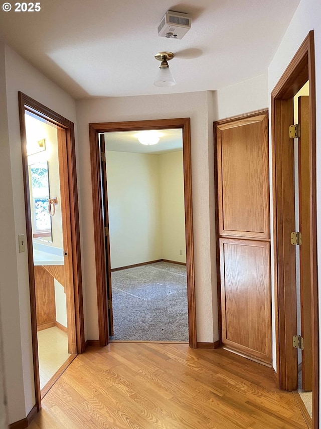 4040 Munsel Creek Dr, Florence, OR 97439 - corridor featuring light wood-type flooring, visible vents, and baseboards