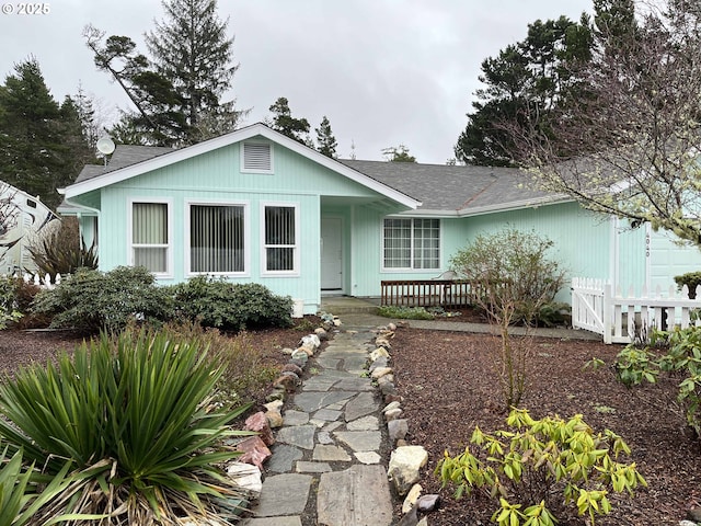 ranch-style home featuring fence and a porch