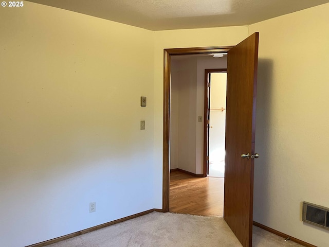 4040 Munsel Creek Dr, Florence, OR 97439 - hall featuring light wood-style floors, a textured ceiling, and baseboards