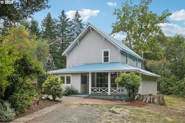 back of house featuring a sunroom