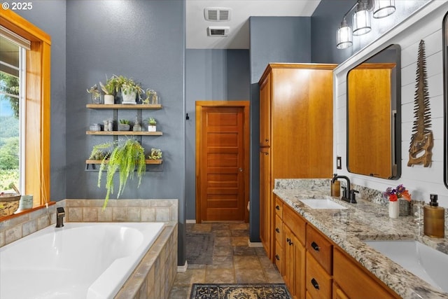 106 Green Valley Rd, Oakland, OR 97462 - full bath featuring a garden tub, stone finish flooring, plenty of natural light, and double vanity