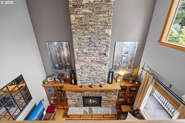 106 Green Valley Rd, Oakland, OR 97462 - living area featuring a stone fireplace, a towering ceiling, and wood finished floors