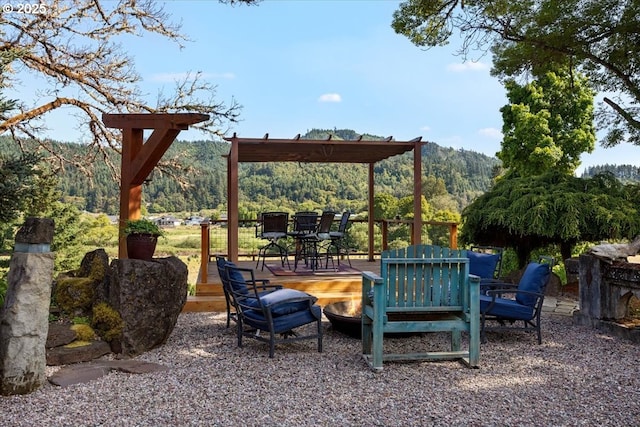 106 Green Valley Rd, Oakland, OR 97462 - view of patio / terrace featuring a fire pit, a deck with mountain view, and outdoor dining space
