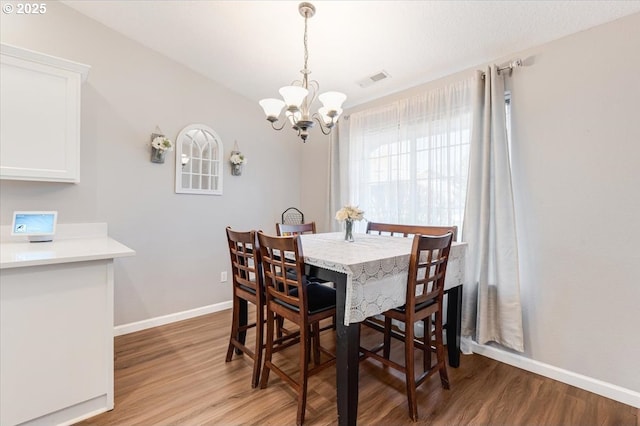 dining room with an inviting chandelier and light wood-type flooring