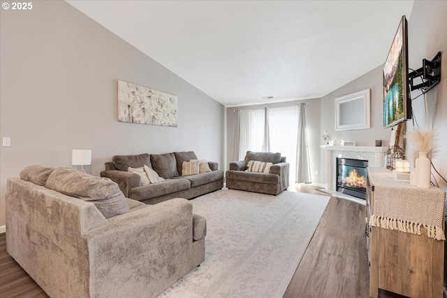 living room featuring lofted ceiling and hardwood / wood-style floors