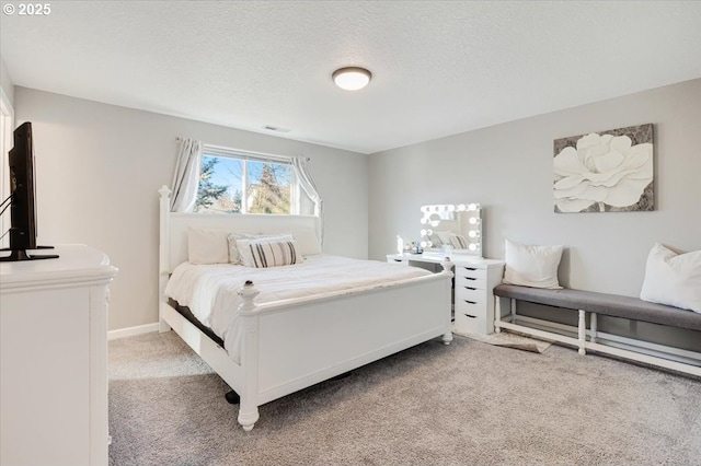 bedroom with carpet and a textured ceiling