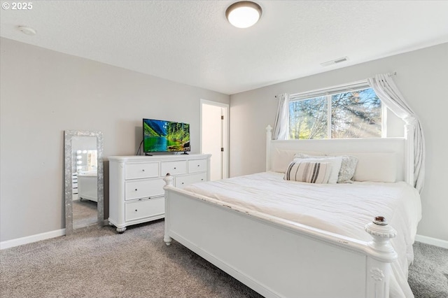 bedroom featuring light carpet and a textured ceiling