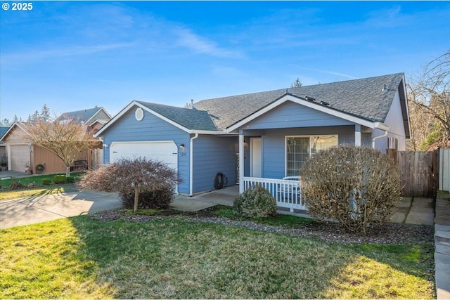 view of front of house featuring a garage, a front yard, and covered porch