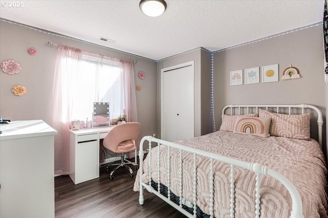 bedroom with hardwood / wood-style floors and a textured ceiling