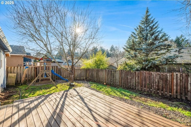 wooden terrace featuring a playground