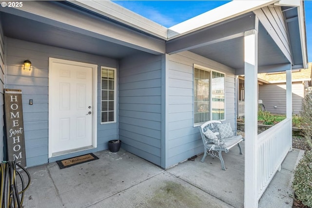 view of exterior entry with a porch