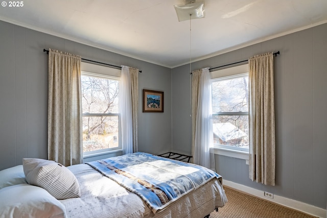 bedroom featuring carpet, multiple windows, crown molding, and baseboards