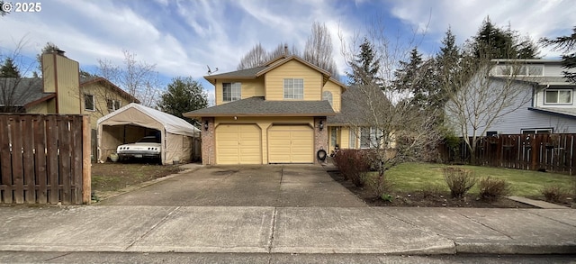 traditional home with brick siding, concrete driveway, a front yard, fence, and a garage