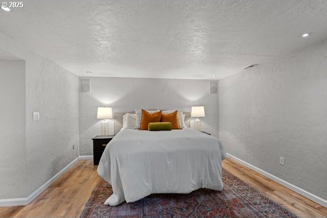 561 E Ridgeway Ave, Hermiston, OR 97838 - bedroom featuring a textured wall, wood finished floors, and a textured ceiling