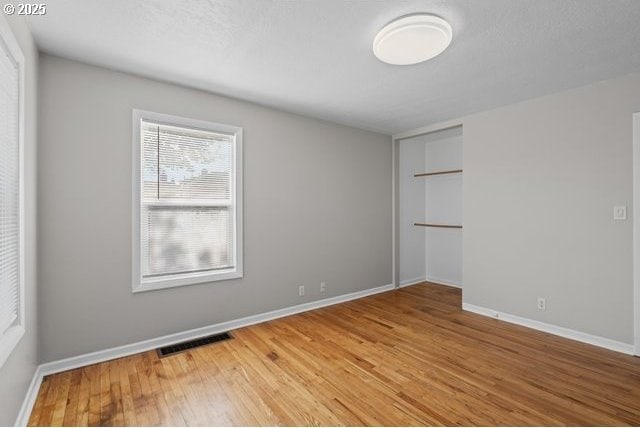 561 E Ridgeway Ave, Hermiston, OR 97838 - unfurnished bedroom with light wood-style floors and a closet