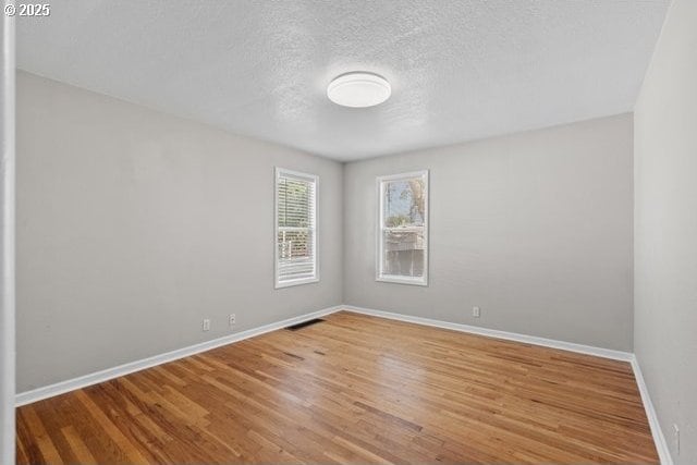 561 E Ridgeway Ave, Hermiston, OR 97838 - unfurnished room featuring wood finished floors and a textured ceiling