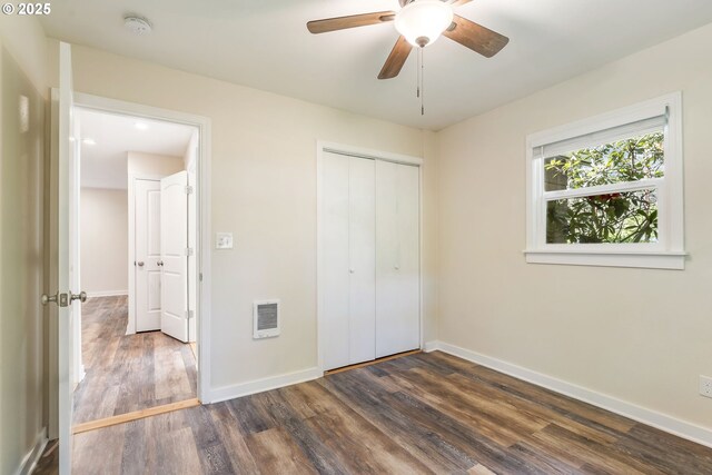 20220 E Peter Pl Unit 3, Sandy, OR 97055 - unfurnished bedroom with dark wood-type flooring, baseboards, heating unit, a closet, and a ceiling fan